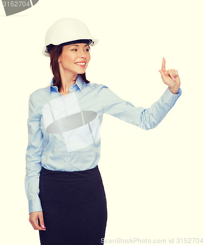 Image of young smiling businesswoman in white helmet