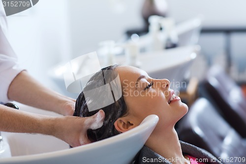 Image of happy young woman at hair salon