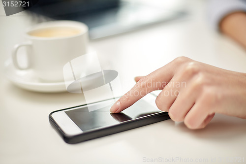 Image of close up of woman hand with smartphone and coffee
