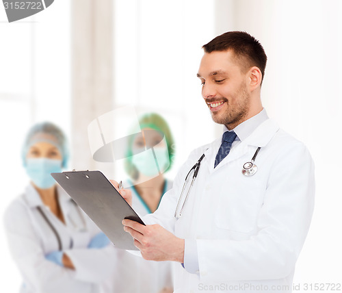 Image of smiling male doctor with clipboard and stethoscope