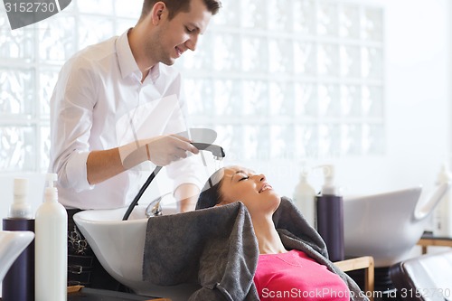 Image of happy young woman at hair salon