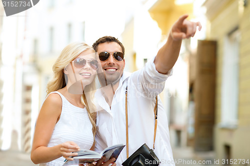 Image of couple with map, camera and travellers guide