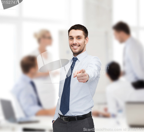 Image of handsome businessman pointing finger at you