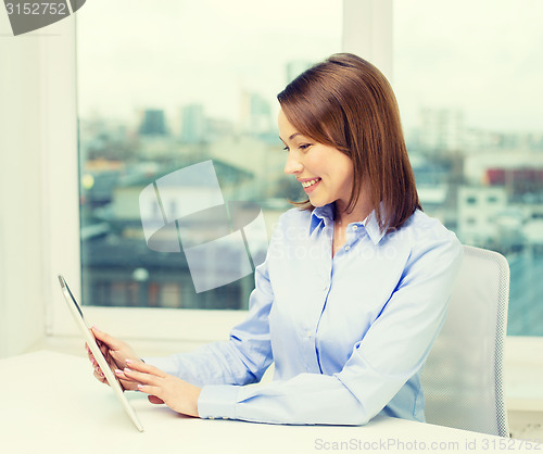 Image of smiling businesswoman with tablet pc