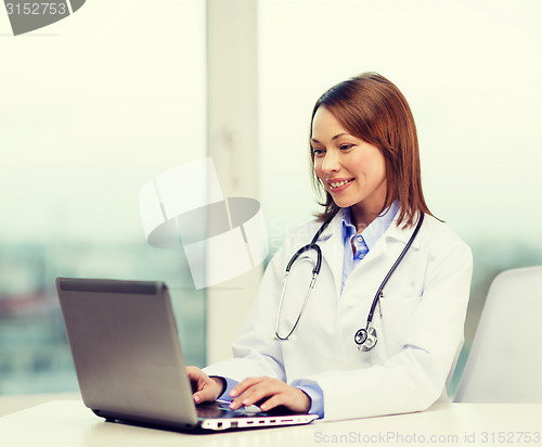 Image of busy doctor with laptop computer