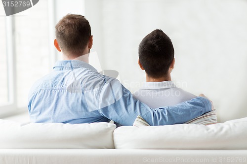 Image of close up of happy male gay couple hugging