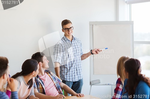 Image of group of smiling students with white board