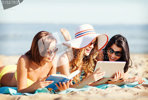 Image of girls with tablet pc on the beach