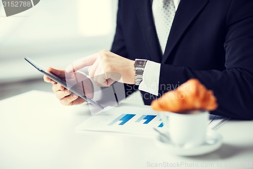 Image of man with tablet pc and cup of coffee