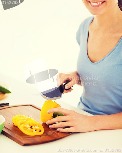 Image of woman cutting vegetables