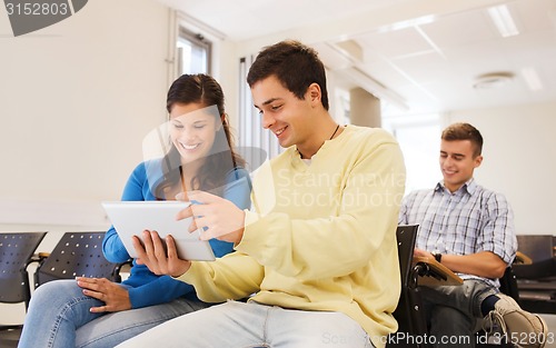 Image of group of smiling students with tablet pc