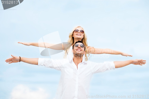 Image of couple holding hands up at sea side