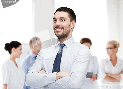 Image of handsome businessman with crossed arms