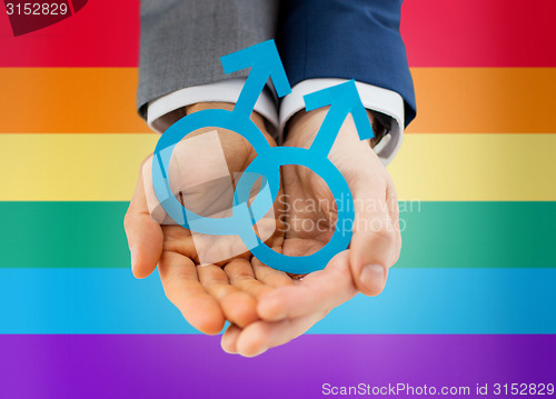 Image of close up of happy male gay couple with love symbol