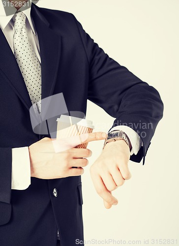 Image of man looking at wristwatch