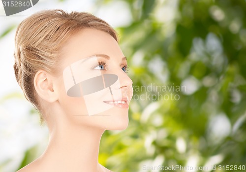 Image of beautiful young woman face over green background
