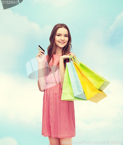 Image of smiling woman in dress with many shopping bags