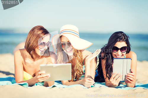 Image of girls with tablet pc on the beach