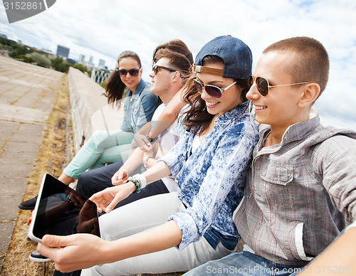 Image of group of teenagers looking at tablet pc