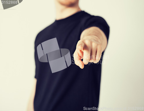 Image of man pointing his finger at you