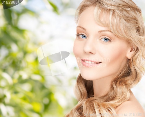 Image of beautiful young woman face with long wavy hair