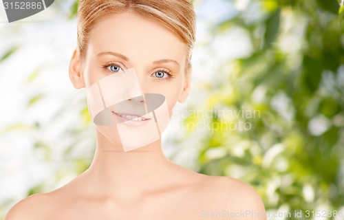 Image of beautiful young woman face over green background