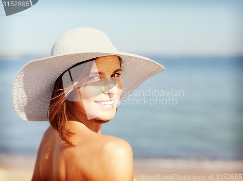 Image of girl in bikini standing on the beach