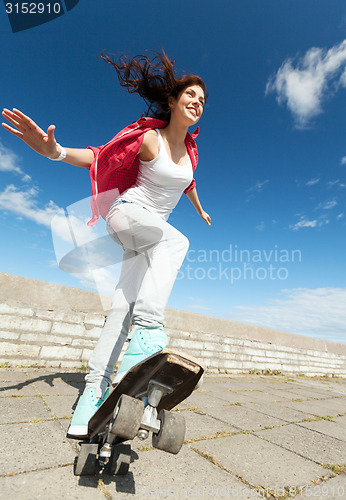 Image of teenage girl skating outside