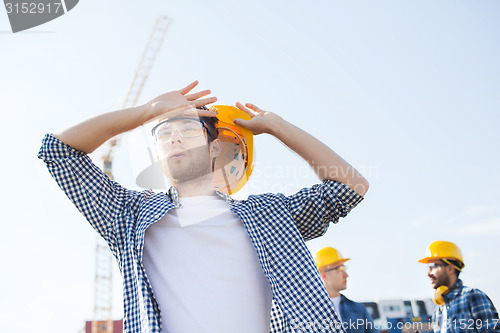 Image of group of builders in hardhats outdoors