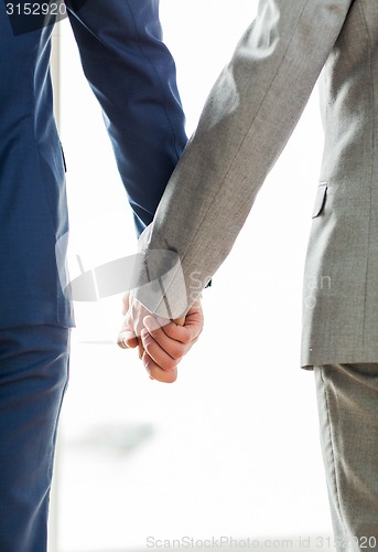 Image of close up of male gay couple holding hands