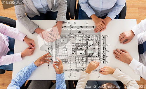 Image of close up of business group with blueprint