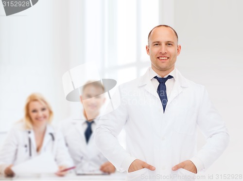 Image of smiling male doctor in white coat