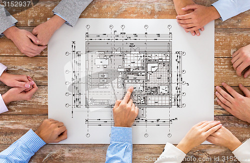 Image of close up of business group with blueprint