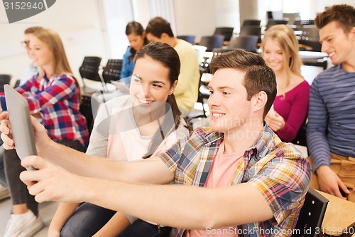 Image of group of smiling students with tablet pc