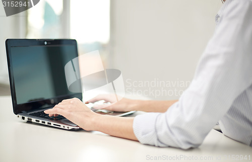 Image of close up of woman typing on laptop at office