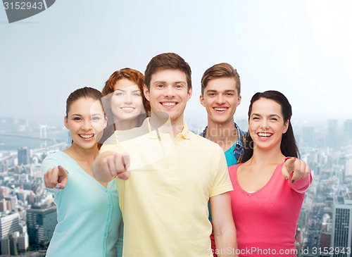 Image of group of smiling teenagers over city background