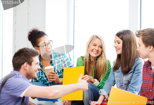 Image of students communicating and laughing at school