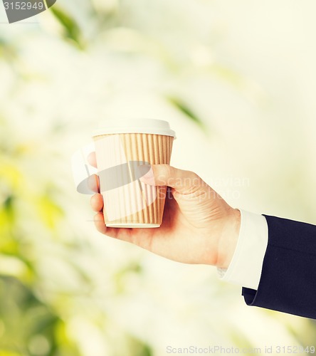 Image of man hand holding take away coffee