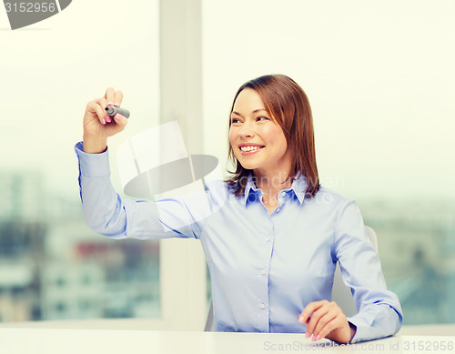 Image of businesswoman writing something in the air