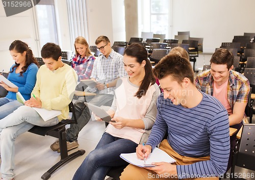 Image of group of smiling students with tablet pc