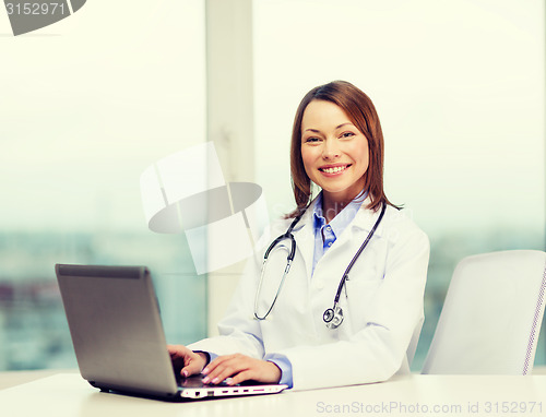 Image of busy doctor with laptop computer