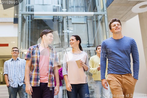 Image of group of smiling students with paper coffee cups