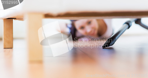 Image of close up of woman with vacuum cleaner at home