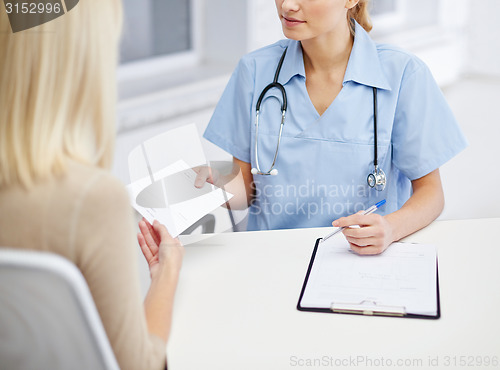 Image of close up of doctor and woman meeting at hospital