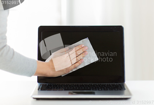 Image of close up of woman hand cleaning laptop screen