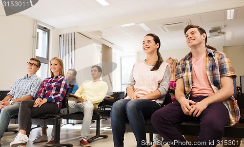 Image of group of smiling students in lecture hall