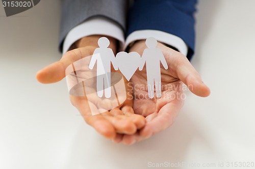 Image of close up of happy male gay couple with love symbol