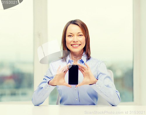 Image of businesswoman with blank smartphone screen