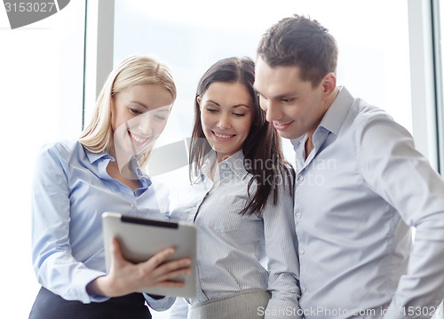 Image of business team working with tablet pc in office