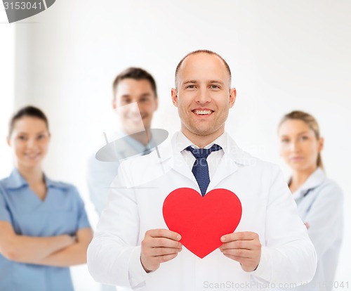 Image of smiling male doctor with red heart